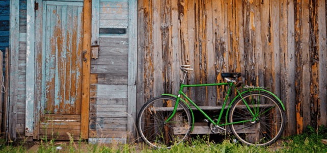 Old wooden wall and green bicycle Old wooden wall and green bicycle